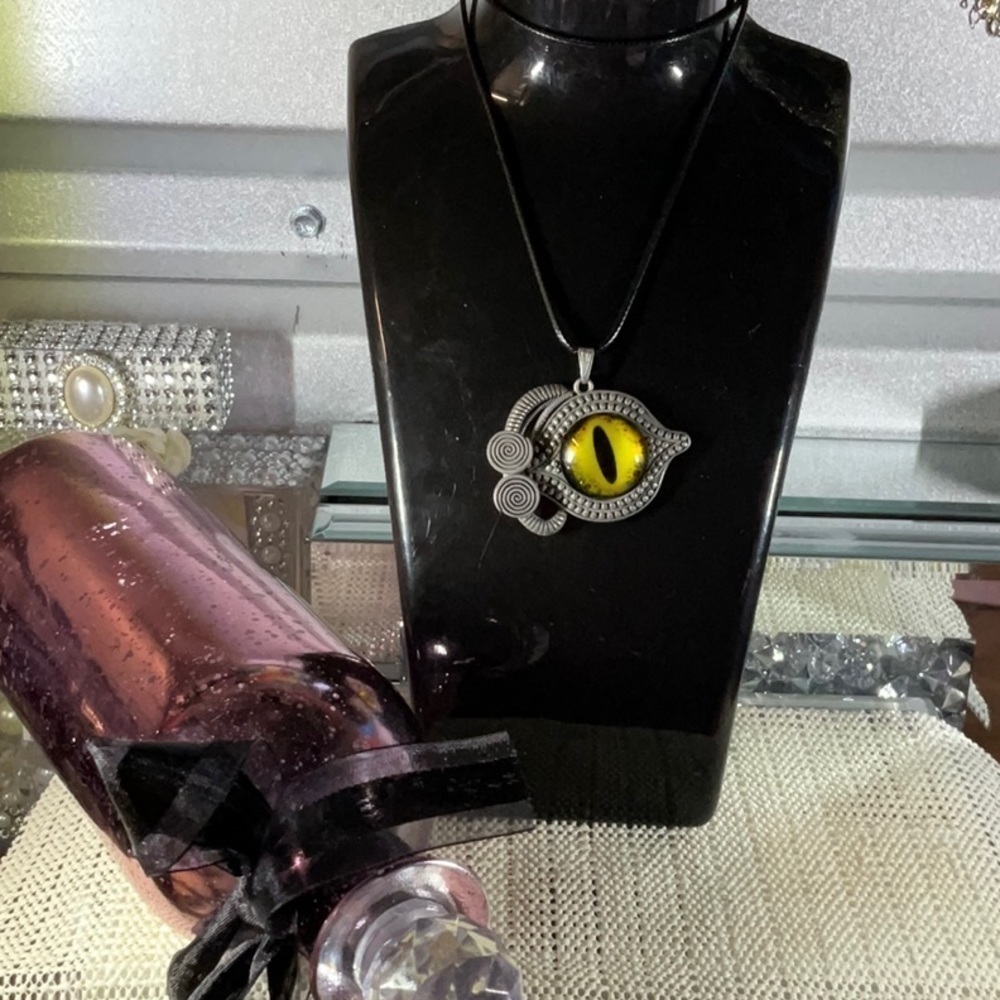 YELLOW EVIL EYE PENDENT ON AN 18” TO 20” BLACK LEATHER NECKLACE